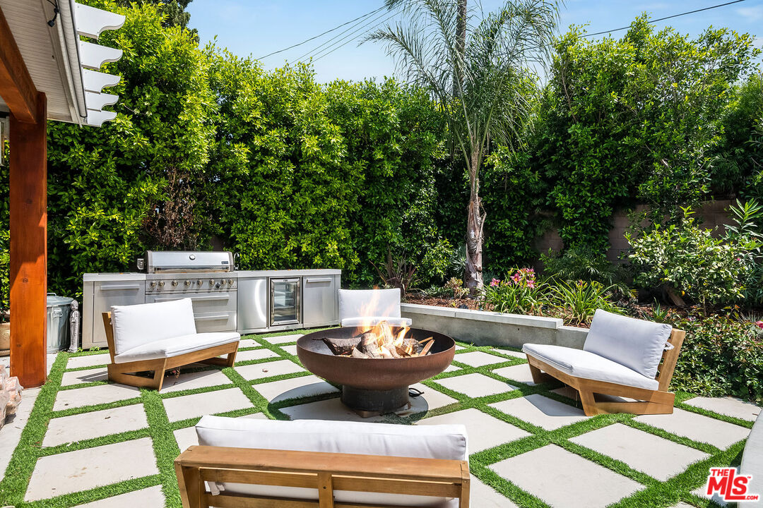 18924 Cantara Street Reseda, CA 91335 - Photo 22 of 31 a view of a patio with a dining table and chairs with a small yard