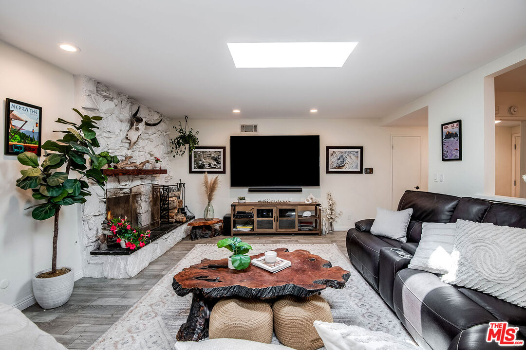 18924 Cantara Street Reseda, CA 91335 - Photo 4 of 31 a living room with furniture a flat screen tv and a fireplace