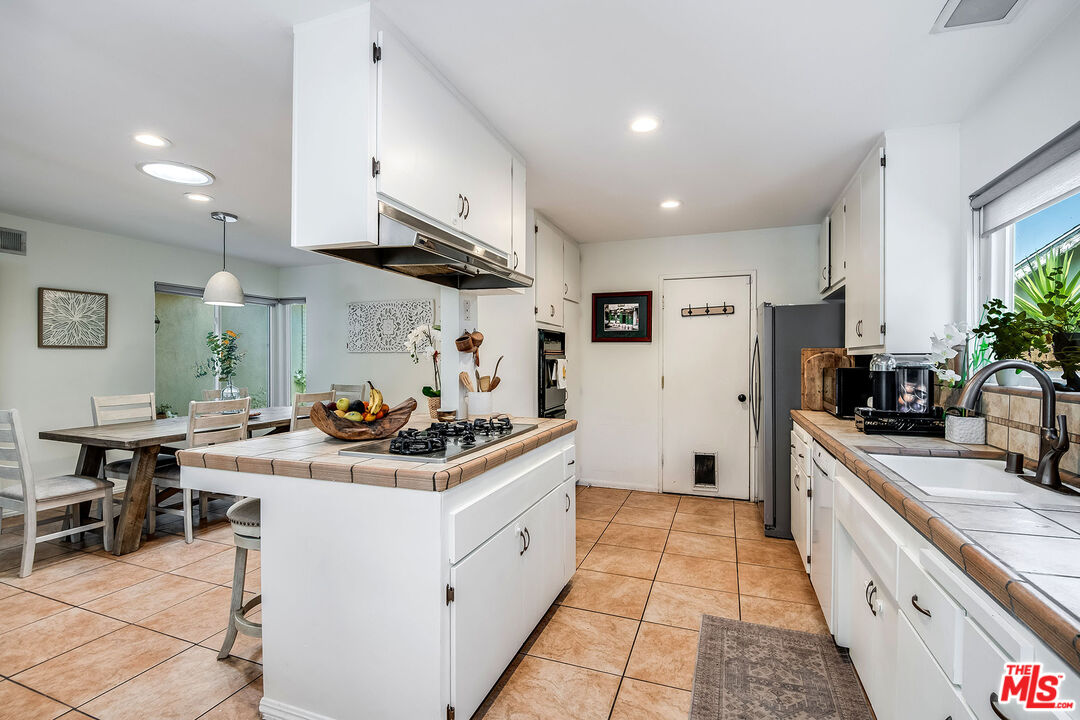18924 Cantara Street Reseda, CA 91335 - Photo 7 of 31 a kitchen with stainless steel appliances granite countertop a sink stove and refrigerator
