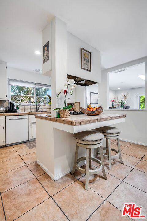 18924 Cantara Street Reseda, CA 91335 - Photo 10 of 31 a kitchen with a sink and cabinets