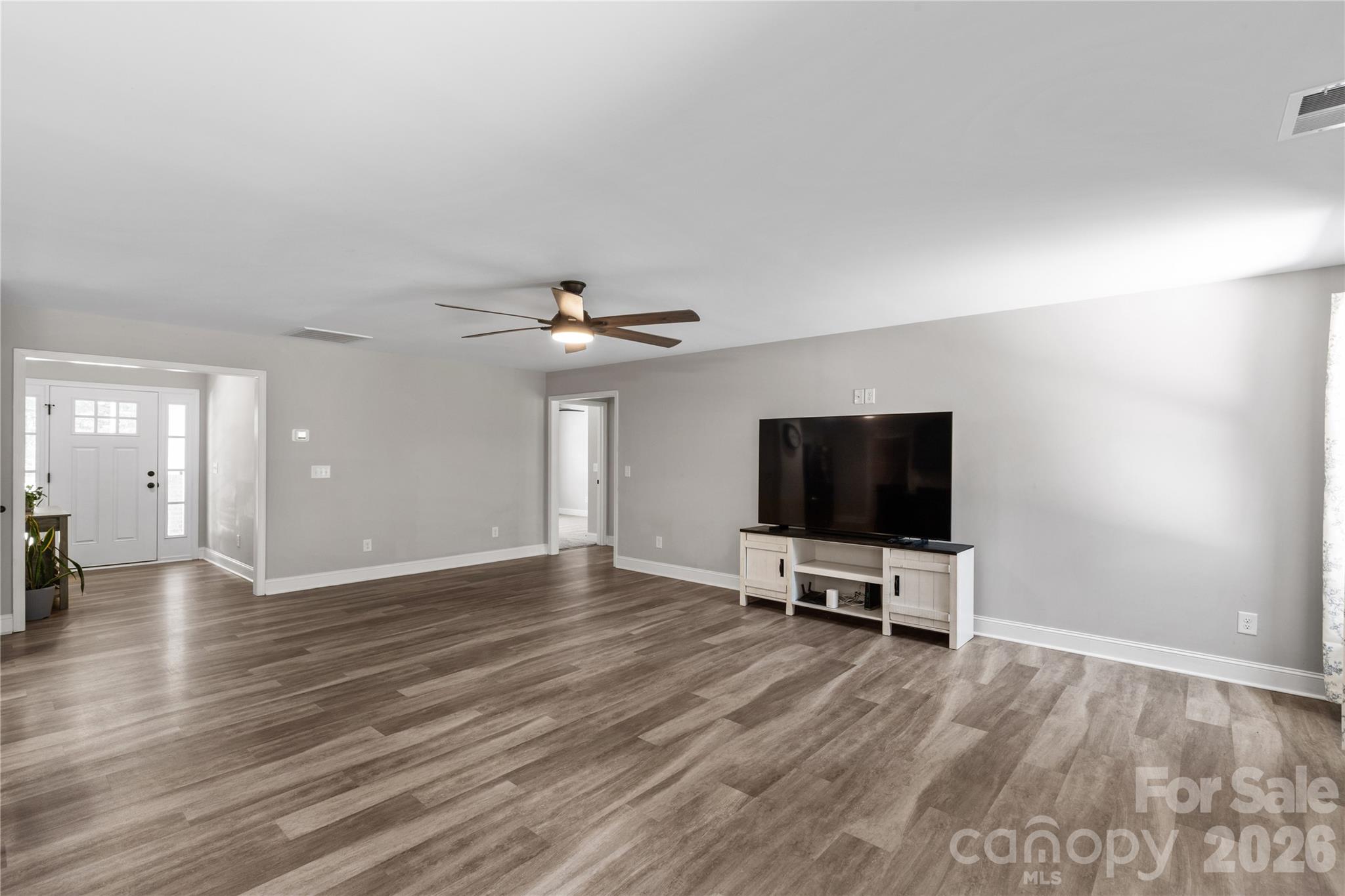 4335 Palmer Lloyd Road Lancaster, SC 29720 - Photo 11 of 33 a view of a livingroom with wooden floor and a flat screen tv