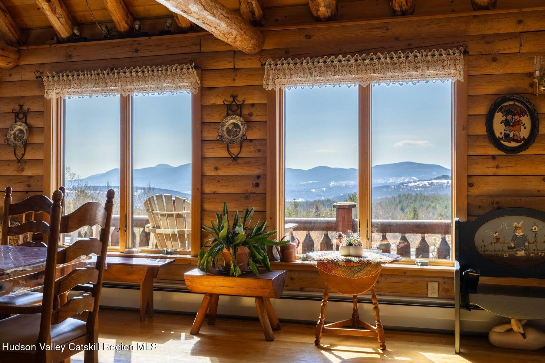 406 Cheese Hill Road Preston Hollow, NY 12469 - Photo 12 of 59 a living room with furniture and a floor to ceiling window