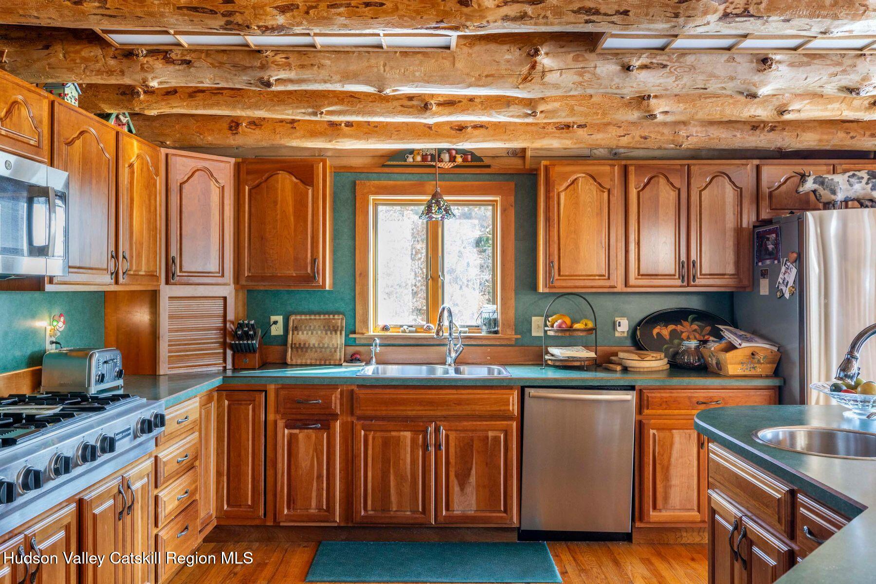 406 Cheese Hill Road Preston Hollow, NY 12469 - Photo 20 of 59 a kitchen with stainless steel appliances granite countertop a sink a stove and cabinets