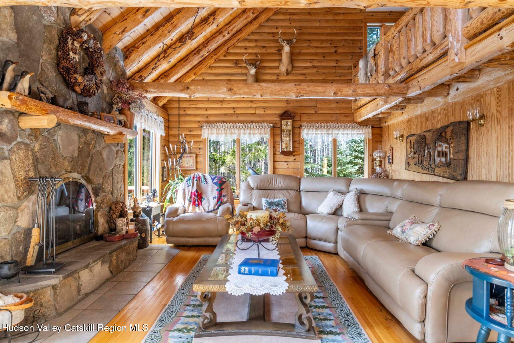 406 Cheese Hill Road Preston Hollow, NY 12469 - Photo 25 of 59 a living room with furniture and a flat screen tv