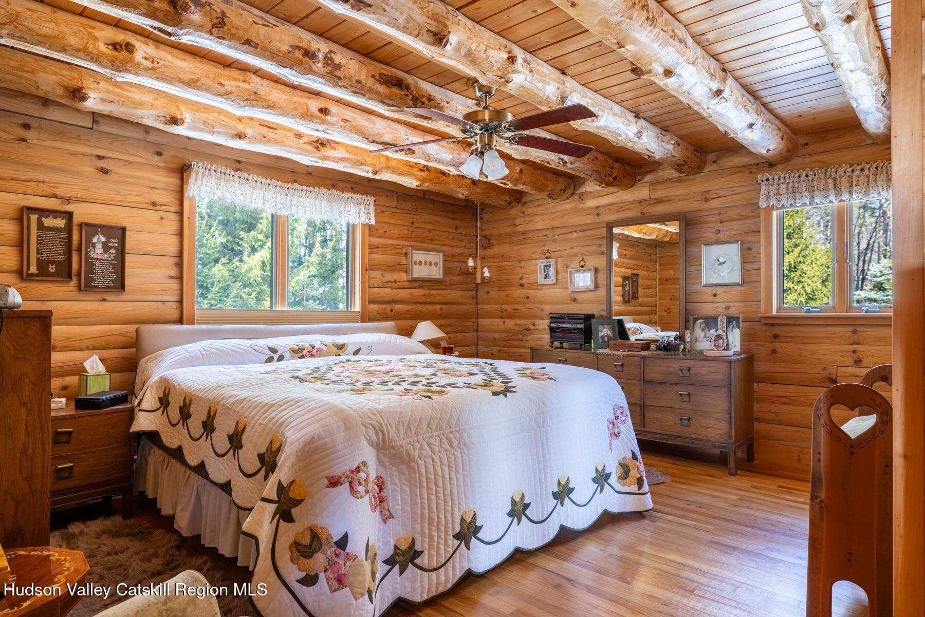 406 Cheese Hill Road Preston Hollow, NY 12469 - Photo 33 of 59 a bedroom with a bed next to a large window with the outer view