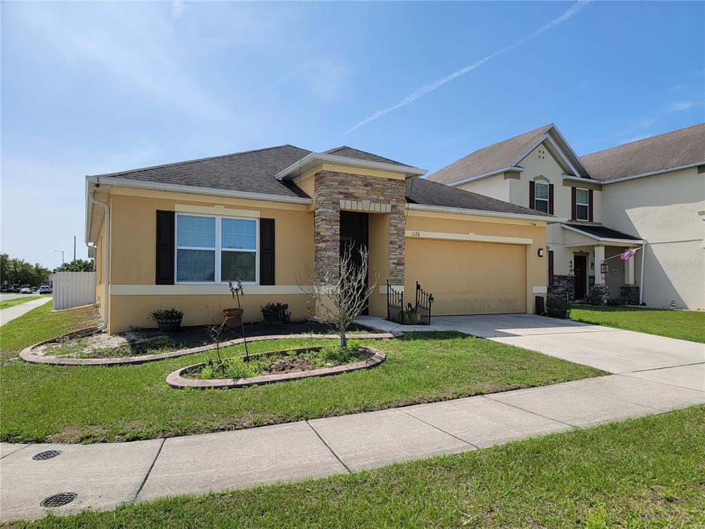 1170 Berkley Ridge Lane Auburndale, FL 33823 - Photo 1 of 1 a front view of a house with a yard and garage