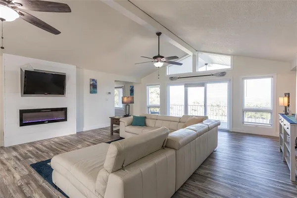 a living room with furniture fireplace and flat screen tv