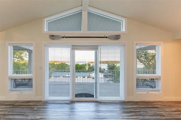 a view of a livingroom with wooden floor and a window
