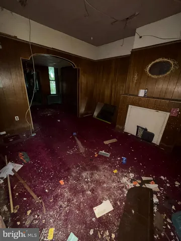 a view of an empty room with a carpet