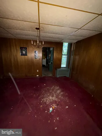 a kitchen with furniture a flat screen tv and refrigerator