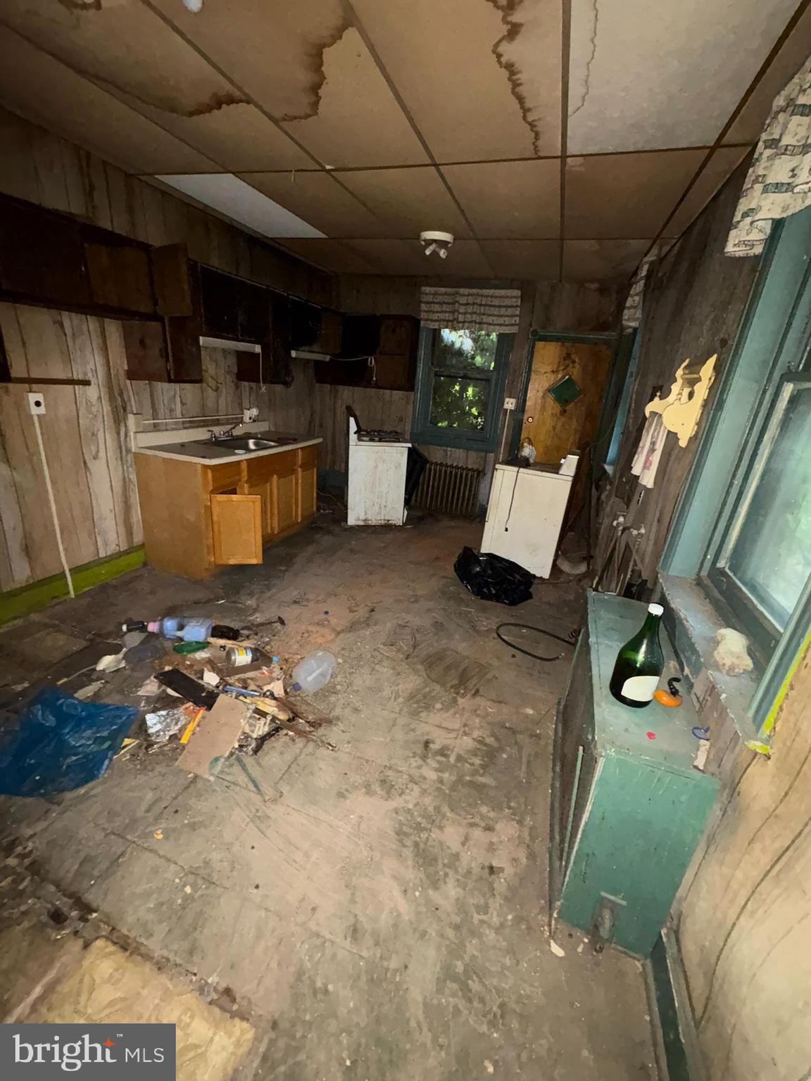 350 North 61st Street Philadelphia, PA 19139 - Photo 9 of 21 a kitchen with furniture a flat screen tv and refrigerator