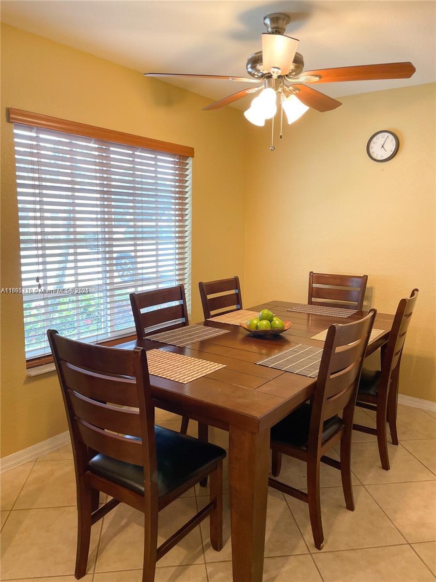5907 London Lane, Unit 5907 Tamarac, FL 33321 - Photo 3 of 10 a view of a dining room with furniture and a chandelier