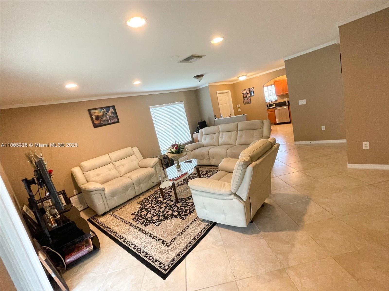 5907 London Lane, Unit 5907 Tamarac, FL 33321 - Photo 5 of 10 a living room with furniture and a rug