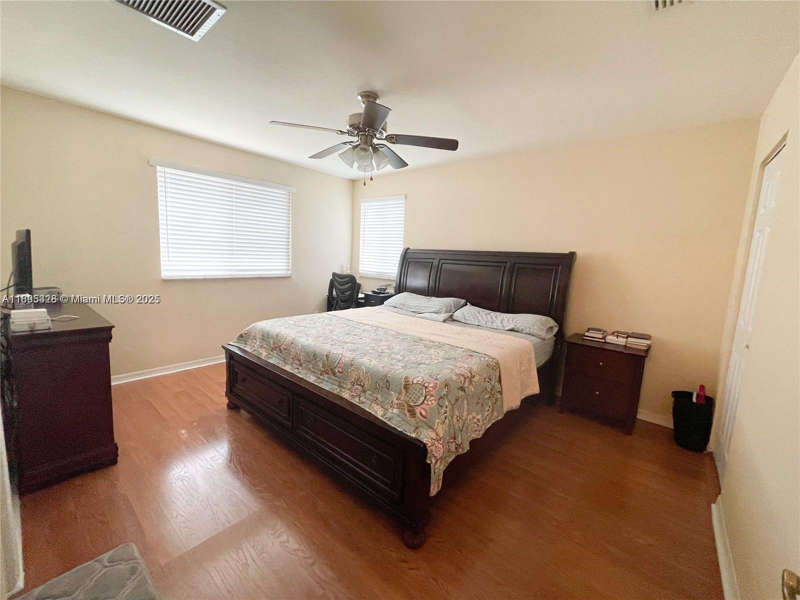 5907 London Lane, Unit 5907 Tamarac, FL 33321 - Photo 7 of 10 a bedroom with a bed and a chandelier