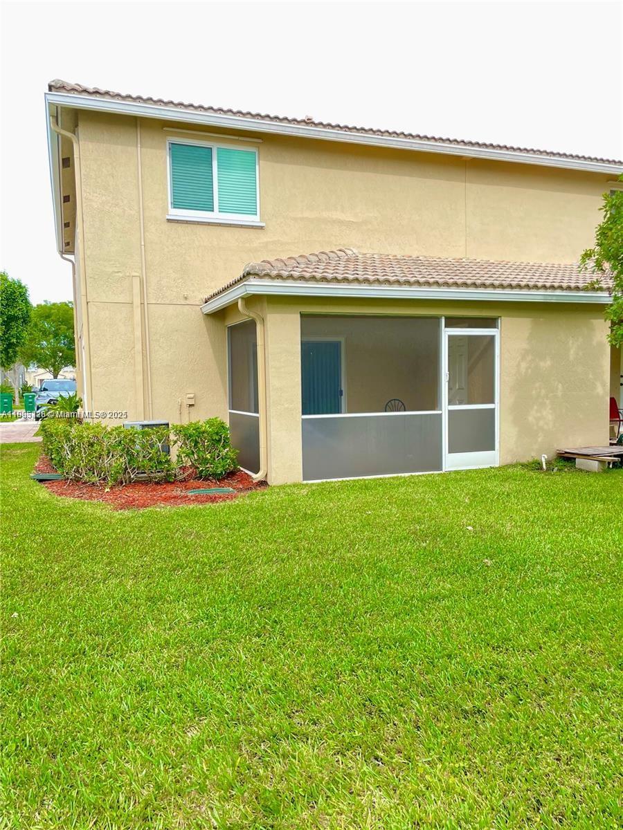 5907 London Lane, Unit 5907 Tamarac, FL 33321 - Photo 10 of 10 a view of a house with a yard and garage
