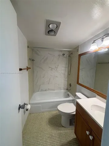 a bathroom with a toilet a sink and shower