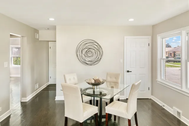 a view of a dining room with furniture and a window