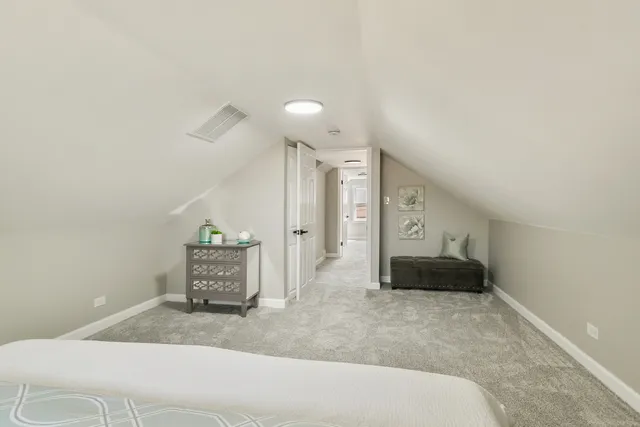 a bedroom with a bed and a large mirror