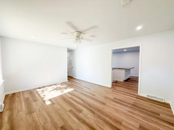 a view of an empty room and wooden floor