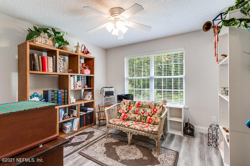 2040 Cornell Road Middleburg, FL 32068 - Photo 34 of 65 a living room with furniture a bookshelf and a window