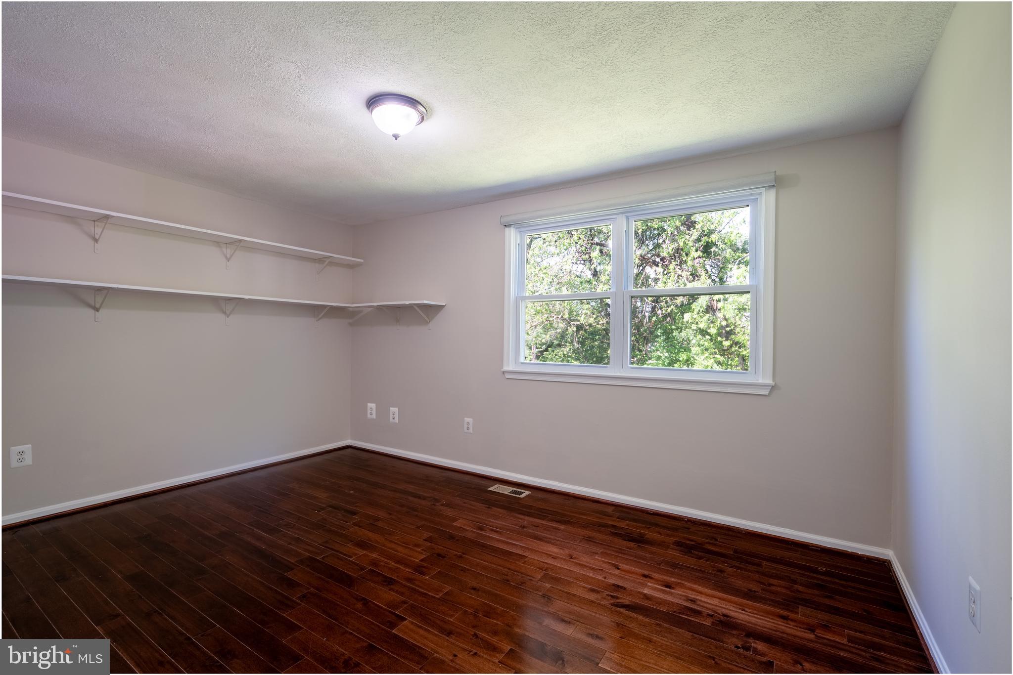 1784 Valleyside Drive Frederick, MD 21702 - Photo 13 of 42 an empty room with wooden floor and windows