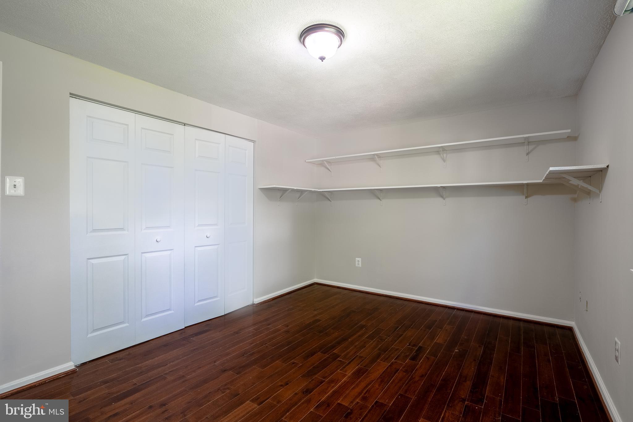 1784 Valleyside Drive Frederick, MD 21702 - Photo 14 of 42 a view of a room with wooden floor and white walls