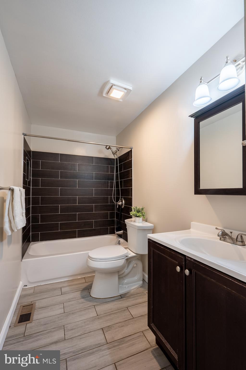 1784 Valleyside Drive Frederick, MD 21702 - Photo 15 of 42 a bathroom with a sink a toilet a mirror and shower