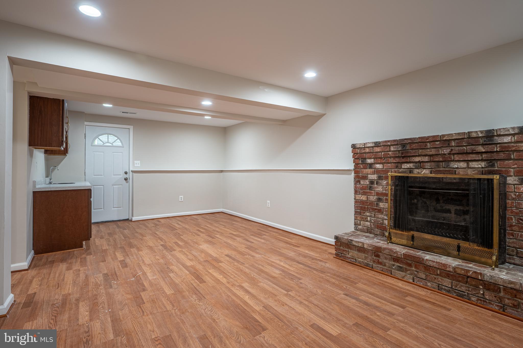 1784 Valleyside Drive Frederick, MD 21702 - Photo 20 of 42 a view of empty room with wooden floor and fireplace