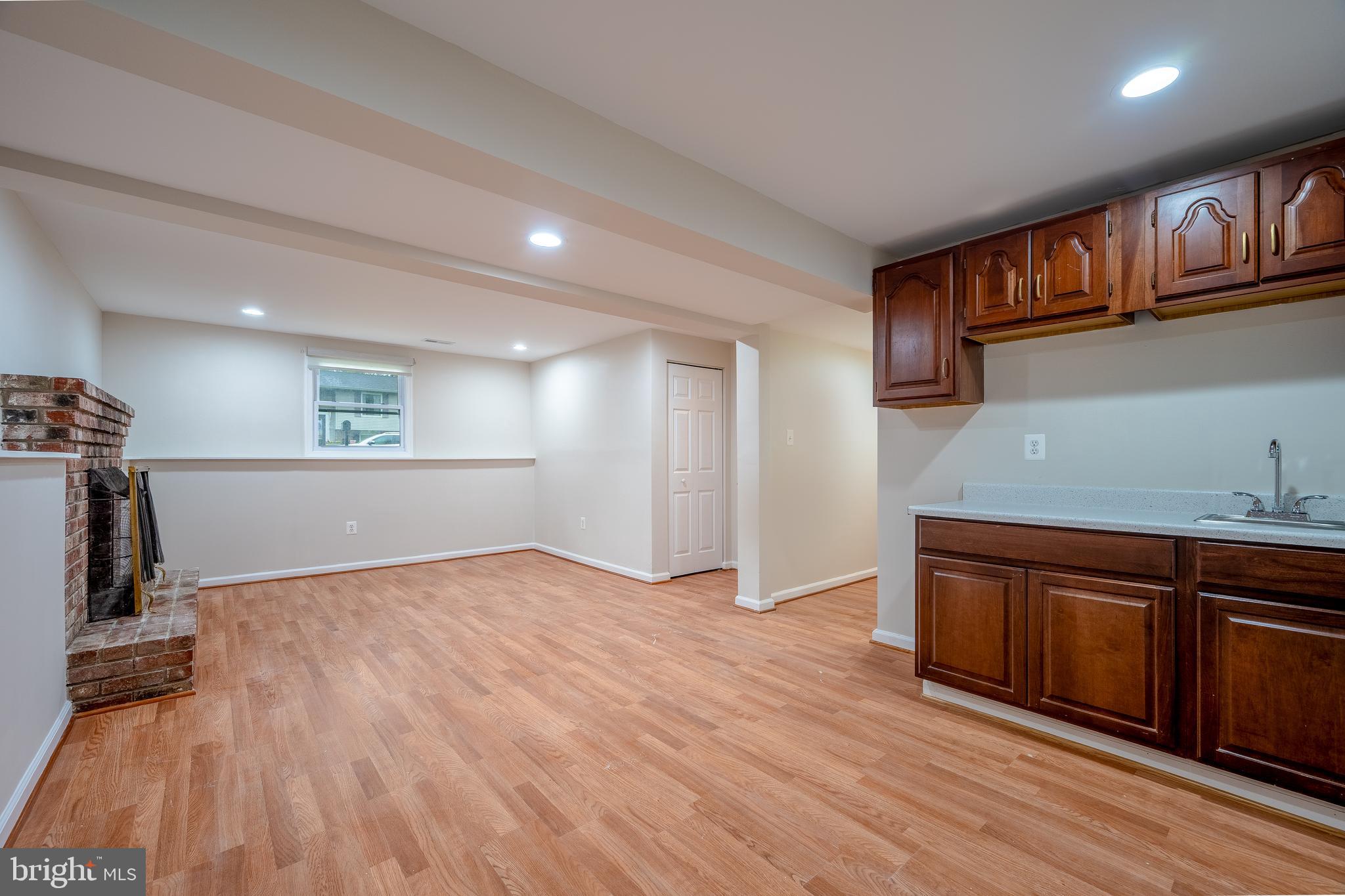 1784 Valleyside Drive Frederick, MD 21702 - Photo 21 of 42 a view of an empty room with wooden floor and a sink