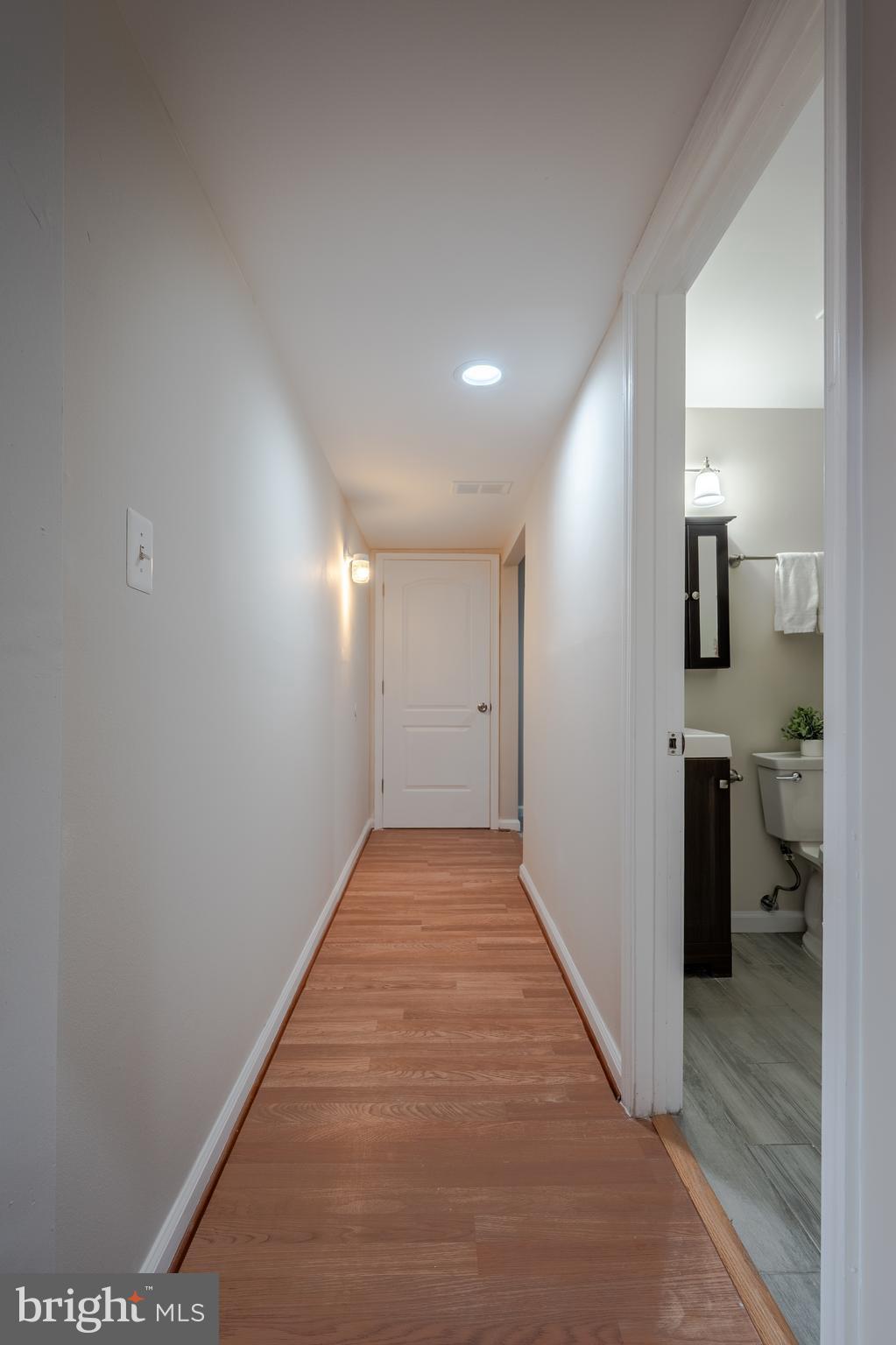 1784 Valleyside Drive Frederick, MD 21702 - Photo 24 of 42 a view of a hallway with wooden floor and a kitchen