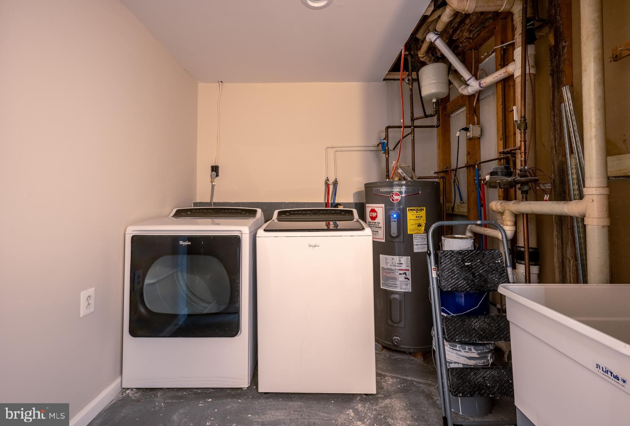 1784 Valleyside Drive Frederick, MD 21702 - Photo 30 of 42 a utility room with dryer washer and a view of living room