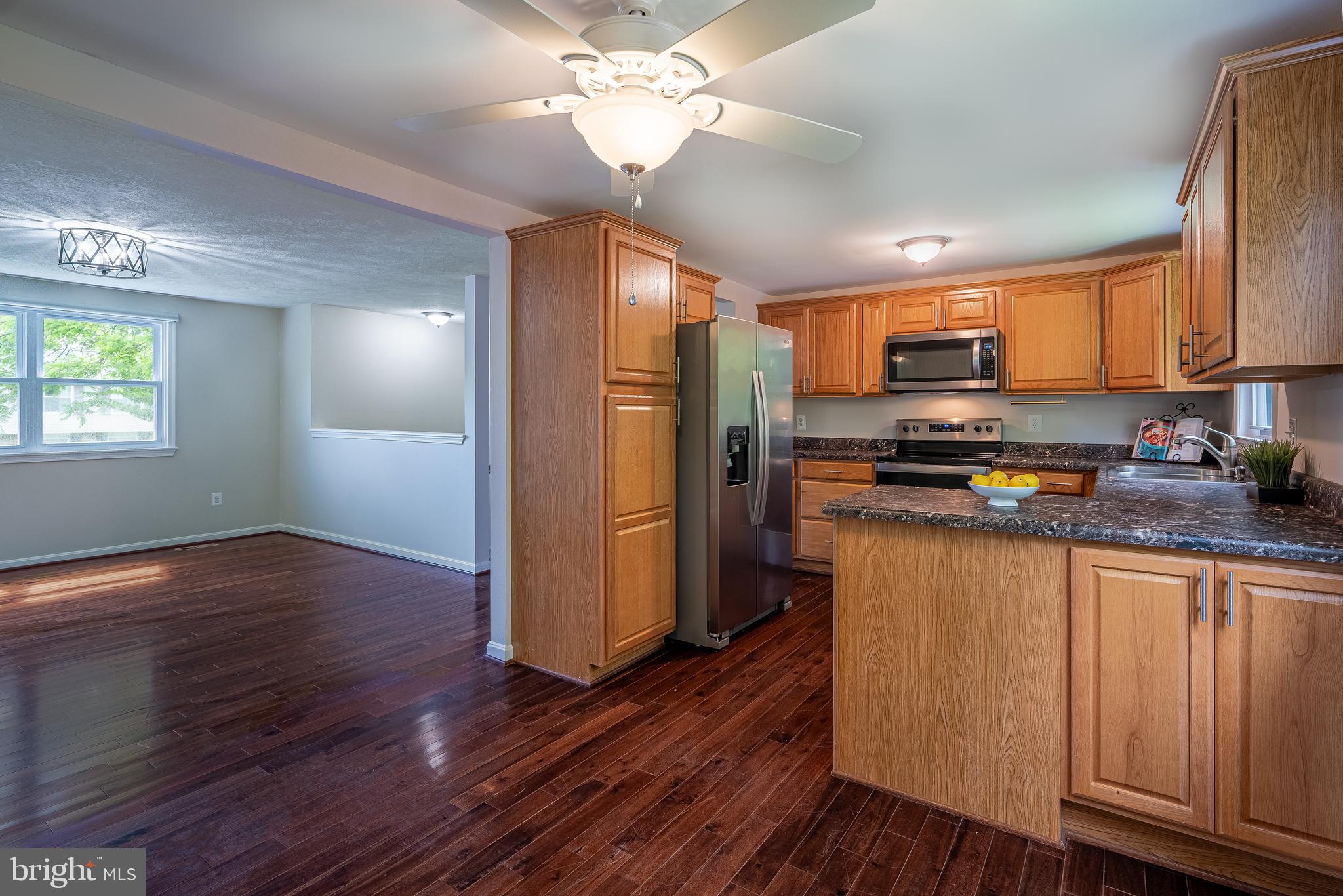 1784 Valleyside Drive Frederick, MD 21702 - Photo 3 of 42 a kitchen with stainless steel appliances a refrigerator stove microwave and cabinets