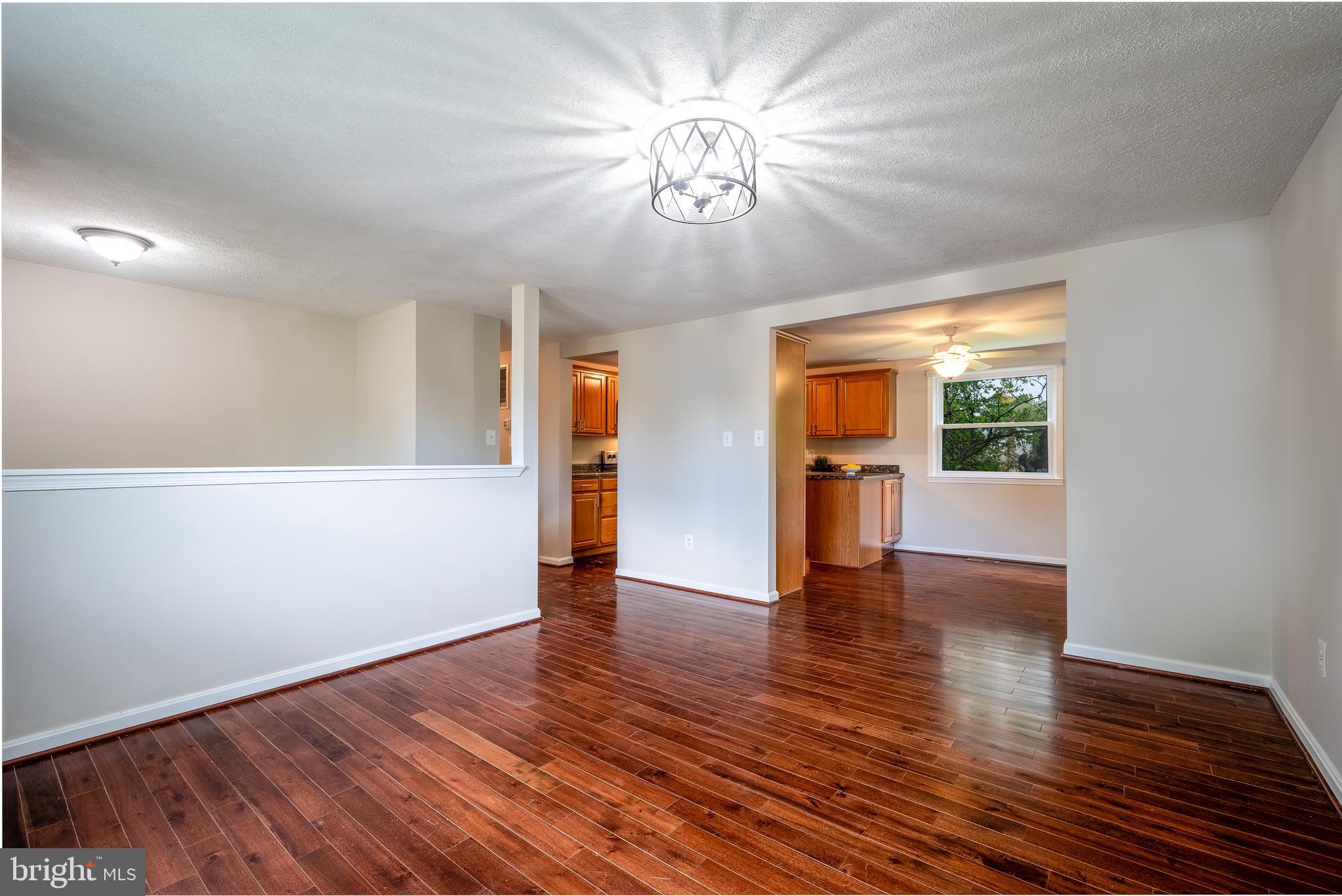 1784 Valleyside Drive Frederick, MD 21702 - Photo 4 of 42 a view of an empty room with wooden floor and a window