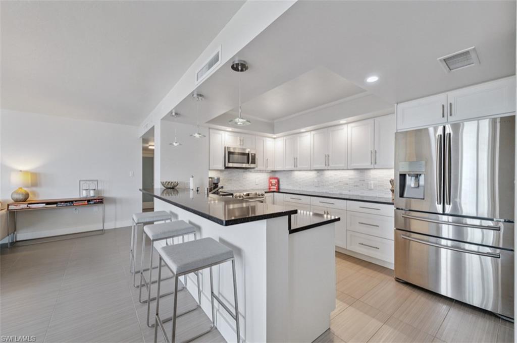 Undisclosed Address Naples, FL 34103 - Photo 8 of 19 Kitchen with stainless steel refrigerator with ice dispenser