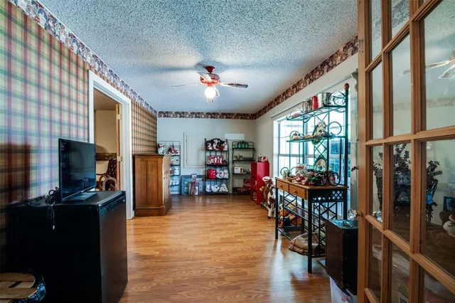 a living room with furniture a flat screen tv and a large window