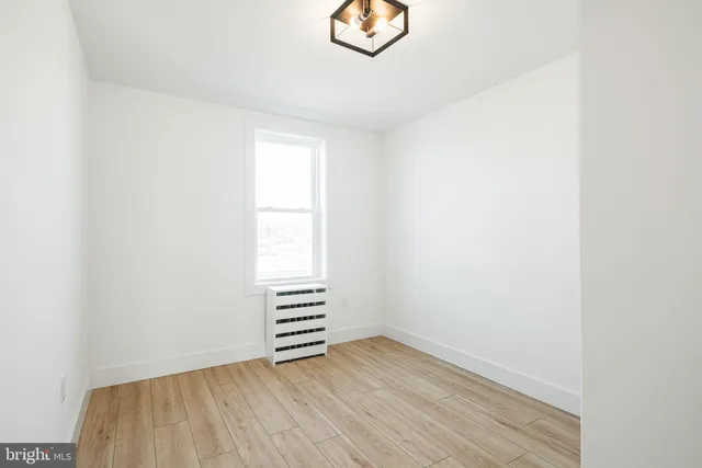 a view of wooden floor and windows in a room