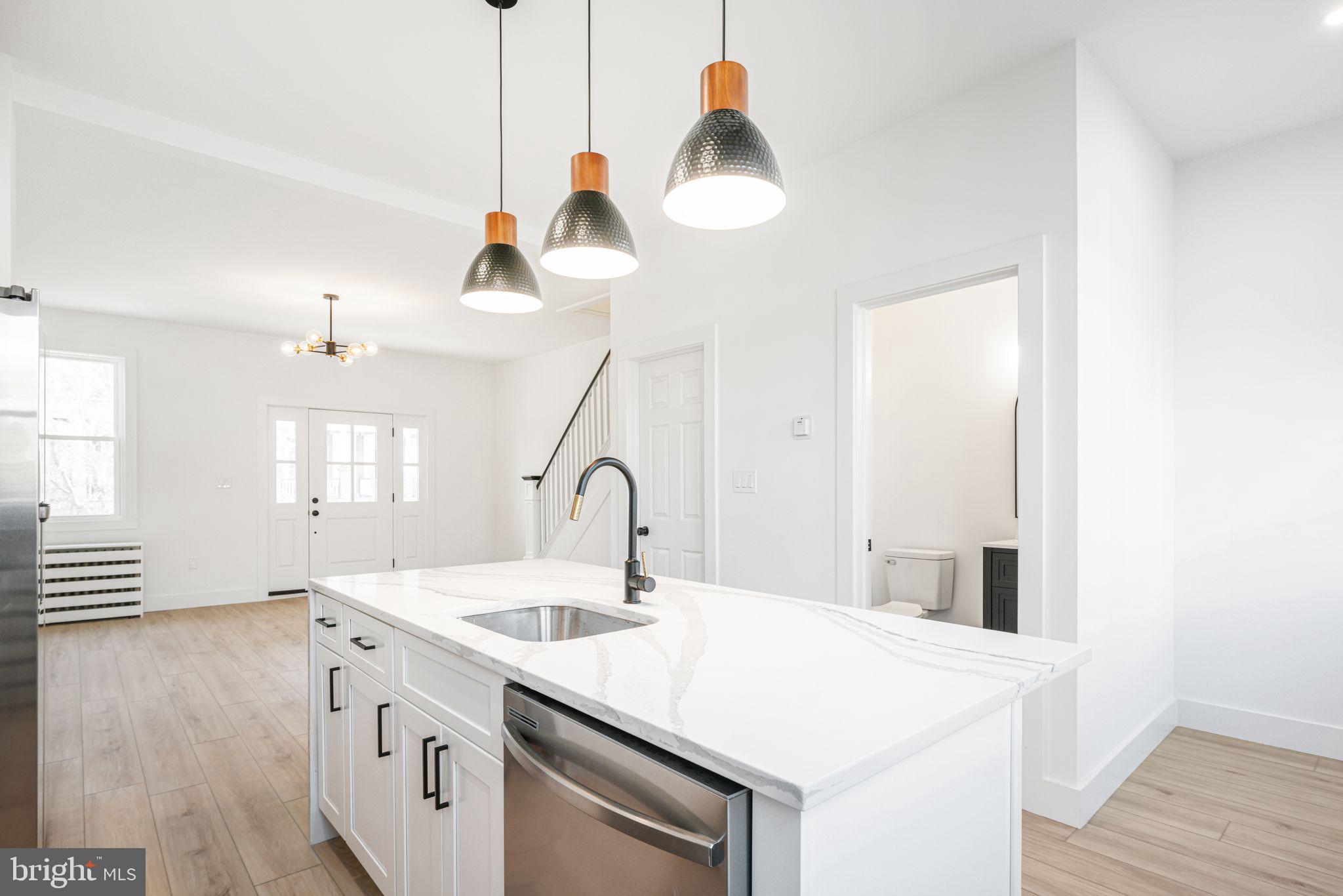 448 Markle Street Philadelphia, PA 19128 - Photo 8 of 21 a kitchen with a sink a stove and wooden floor