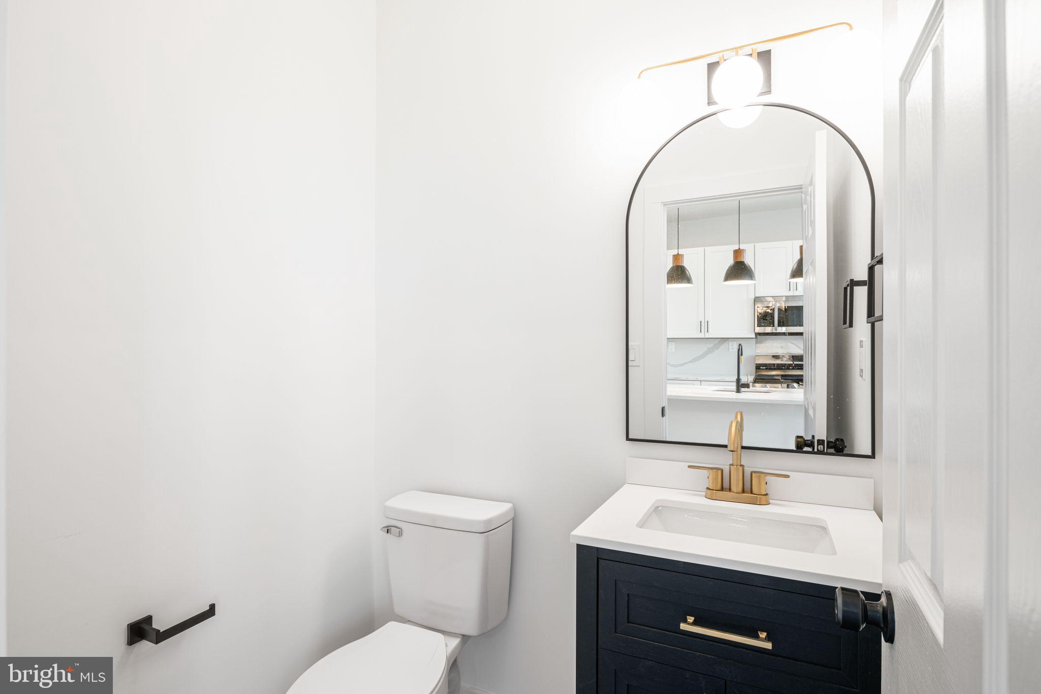 448 Markle Street Philadelphia, PA 19128 - Photo 9 of 21 a bathroom with a toilet a sink and mirror