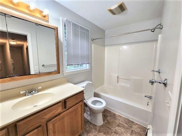 74 Lackey Dam Road Sutton, MA 01590 - Photo 13 of 17 a bathroom with a sink a toilet and a bathtub