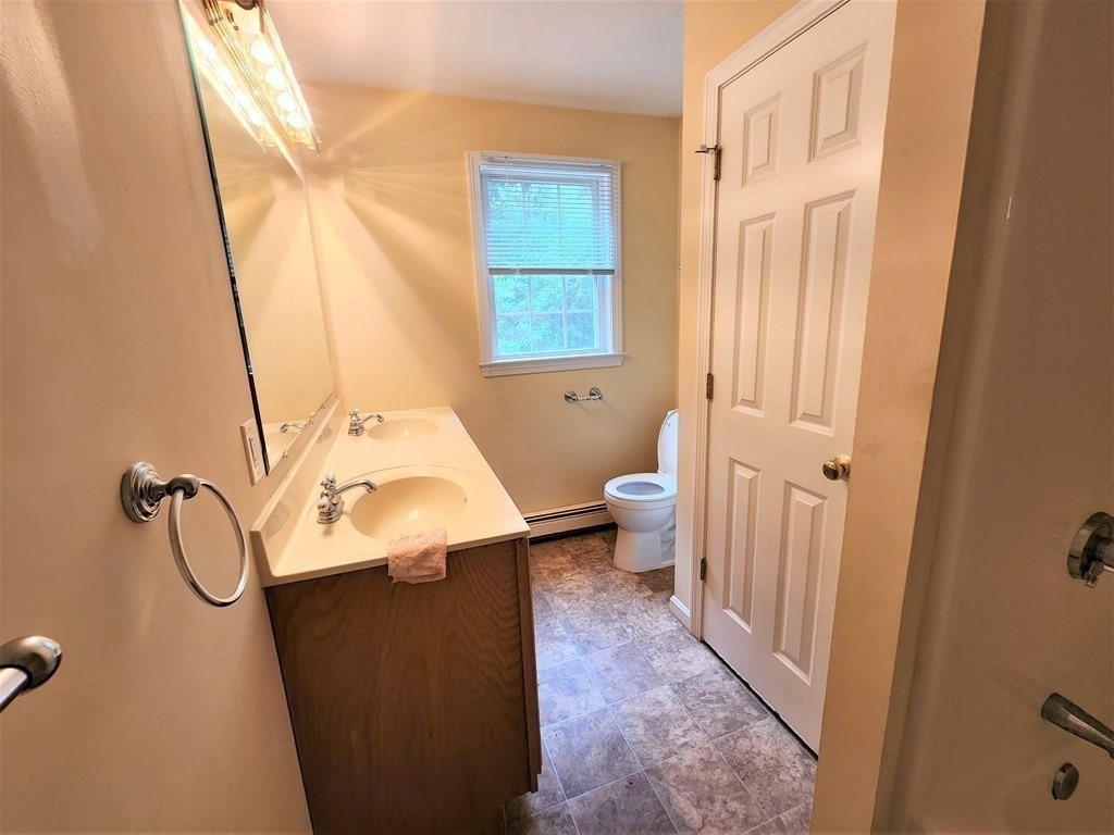 74 Lackey Dam Road Sutton, MA 01590 - Photo 14 of 17 a bathroom with a sink a toilet and shower