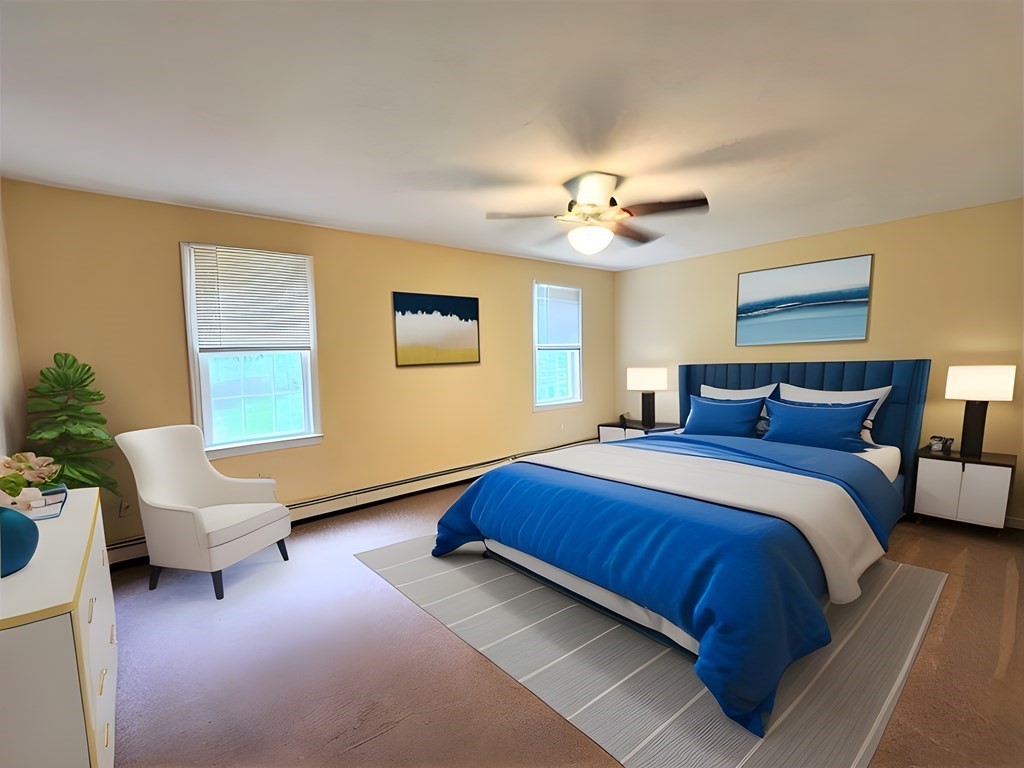 74 Lackey Dam Road Sutton, MA 01590 - Photo 17 of 17 a spacious bedroom with a bed a couch and a chandelier