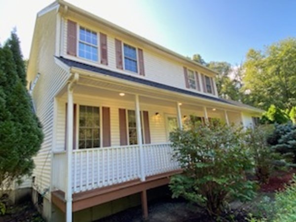 74 Lackey Dam Road Sutton, MA 01590 - Photo 3 of 17 a view of a brick building next to a yard