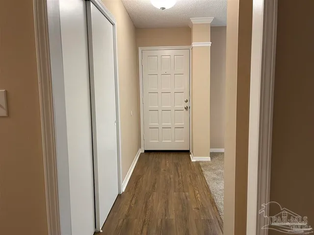 a view of a hallway with wooden floor