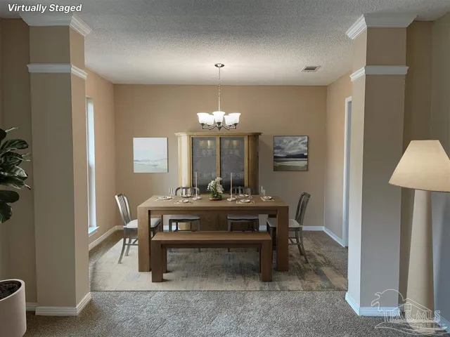 a view of a dining room with furniture and chandelier