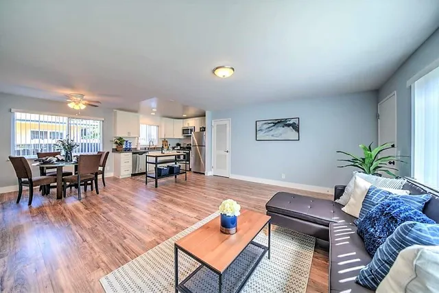 a living room with furniture and wooden floor
