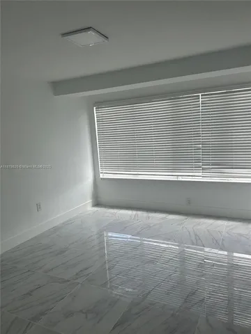 a kitchen with cabinets stainless steel appliances and wooden floor