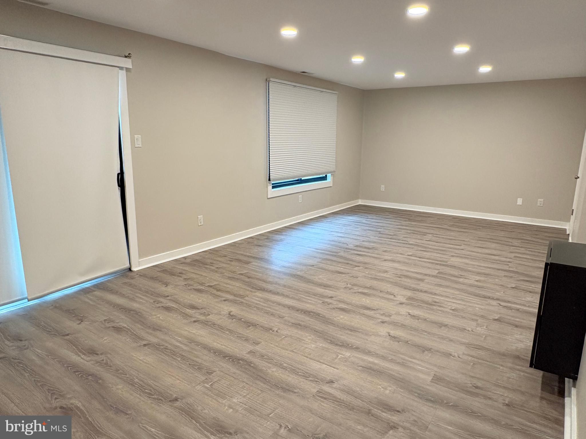 601 Gregorys Way Voorhees, NJ 08043 - Photo 3 of 8 an empty room with wooden floor and windows