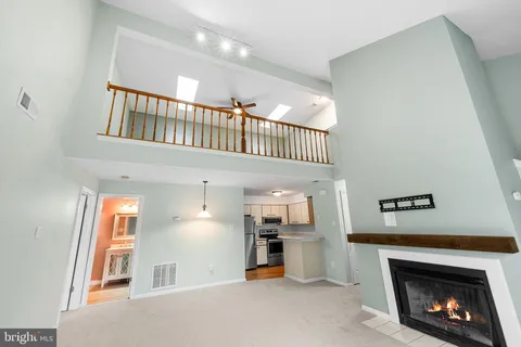 a view of a livingroom with a fireplace and workspace