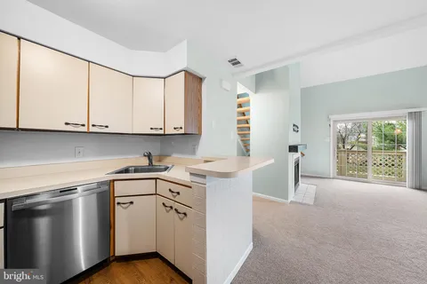 a kitchen with stainless steel appliances granite countertop a sink a stove and a microwave