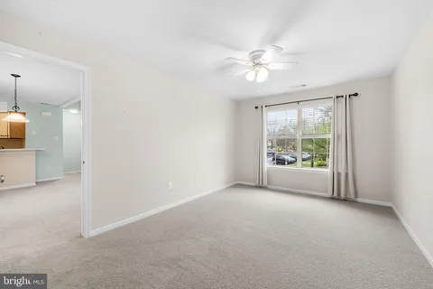 a view of a livingroom with a ceiling fan and window